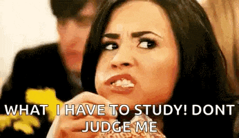 a woman is eating a sandwich and says `` what i have to study ! don 't judge me '' .