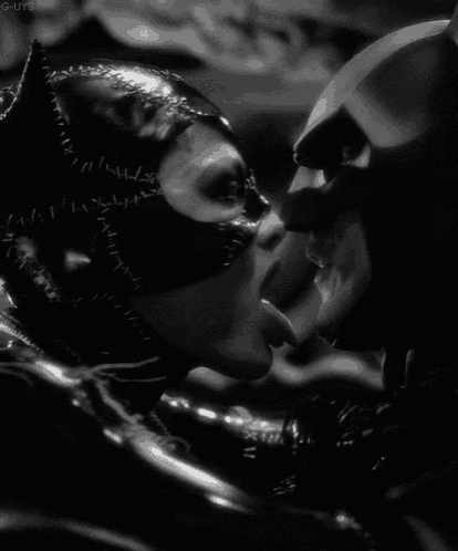 a black and white photo of batman and catwoman