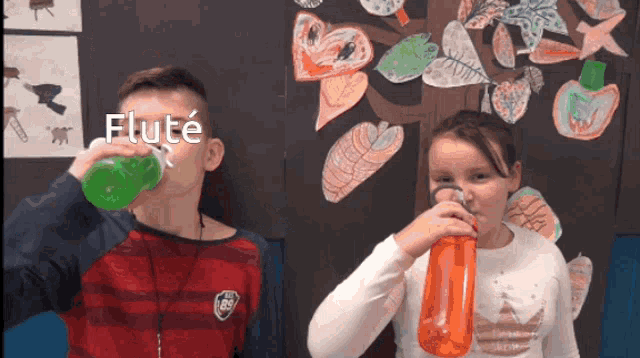 a boy and a girl drinking from a bottle with the word flute written on it