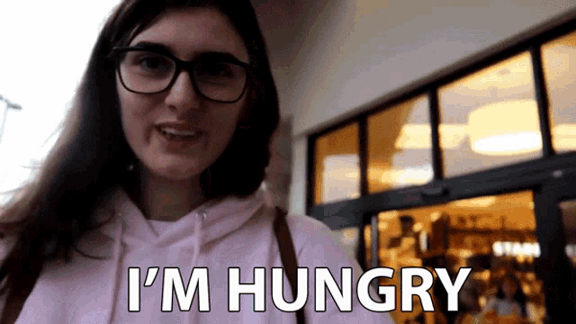 a woman wearing glasses says i 'm hungry