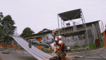 a man is cutting a piece of metal in front of a building that says ' scaffolding ' on it