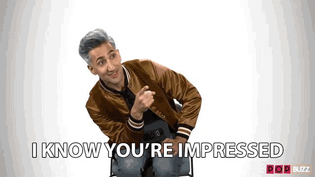 a man sitting in a chair with the words i know you 're impressed
