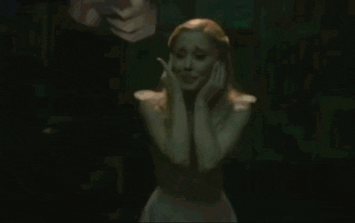 a woman with long blonde hair is tied up in a dark room .
