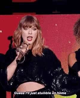 a woman is singing into a microphone and says " guess i 'll just stumble on home " .
