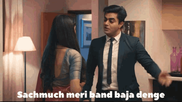 a man in a suit and tie talks to a woman