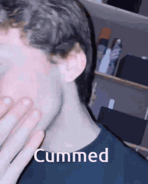 a close up of a person 's face with the word cummed written on it
