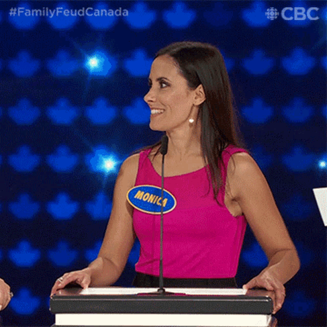 a woman in a pink tank top has a name tag that says monica