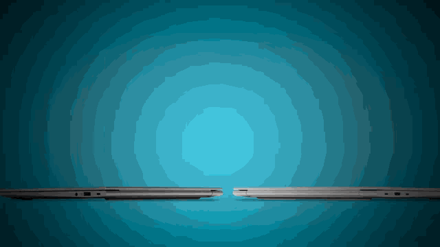 two laptops on a blue background one is open and the other is closed