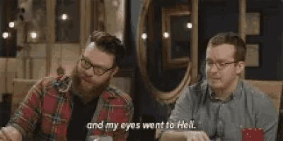 two men are sitting at a table and one of them is saying `` and my eyes went to hell . ''