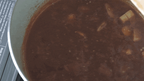 a pot of soup is being cooked on a stove with a label that says " mode " on it