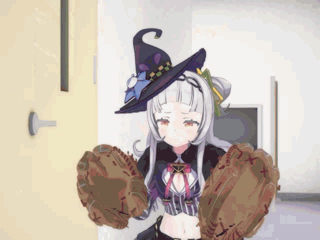 a girl in a witch hat is holding a baseball glove with the letter x on it