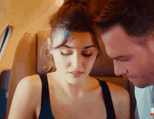 a man and a woman are looking at each other