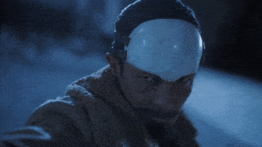 a man with a white mask on his head .