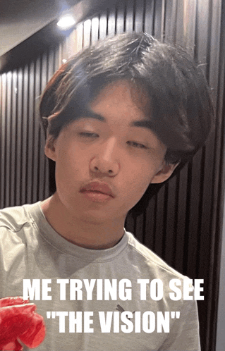 a picture of a young man with the caption " me trying to see "