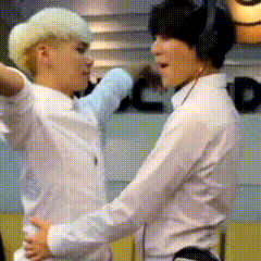 two men in white shirts are hugging each other