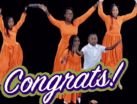 a group of people in orange dresses are dancing in front of a sign that says congrats