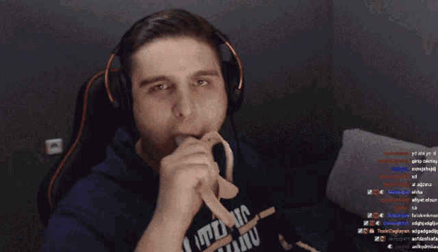 a man wearing headphones is sitting in front of a computer monitor with a bunch of messages on it
