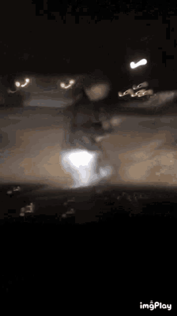 a blurry picture of a person dancing at night .
