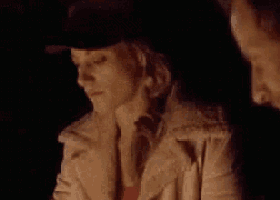 a man and a woman are sitting next to each other in a dark room .