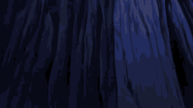 a person holding a sword in the air with a blue light coming out of it
