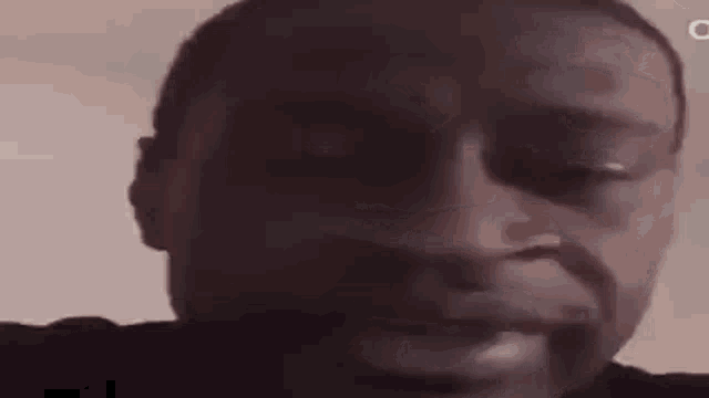 a close up of a man 's face with his eyes closed and his mouth open .