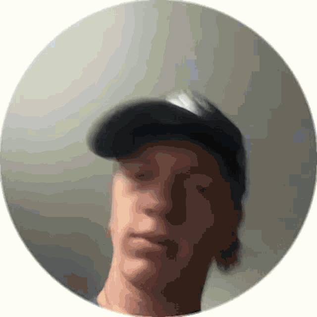 a blurry picture of a man wearing a baseball cap .