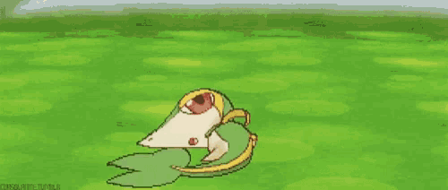 a pokemon is laying on its back on a green field .