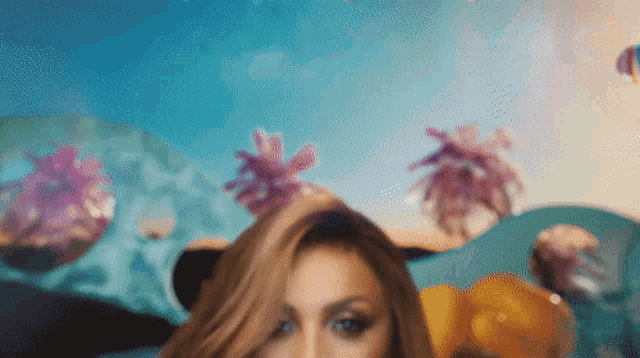 a blurry picture of a woman 's face with a blue sky in the background