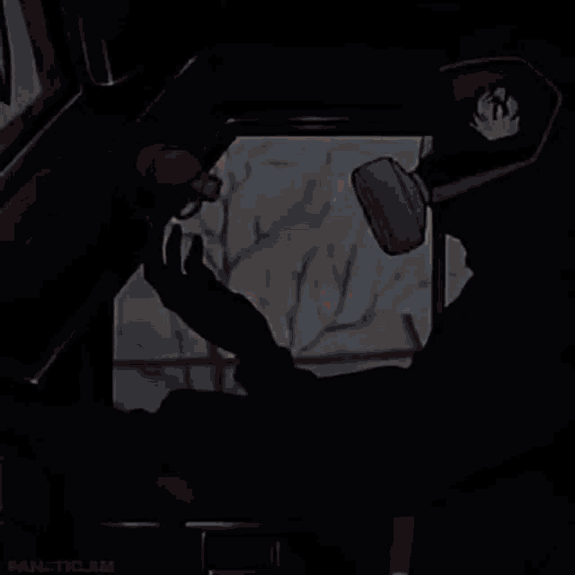 a person is holding a spray can and pointing at it .
