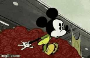 a cartoon of mickey mouse is sitting on a pile of meat .