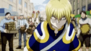 a man in a blue and yellow outfit is standing in front of a group of people .