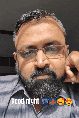 a man with glasses and a beard has the words good night written above him
