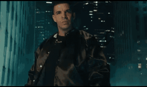 a man in a brown jacket looks at the camera