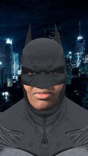 a man in a batman costume is standing in front of a city skyline