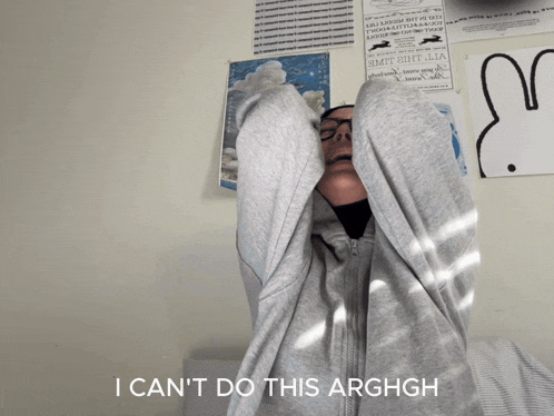a woman with glasses and a hijab is crying with the words " i can 't do this arghgh " below her
