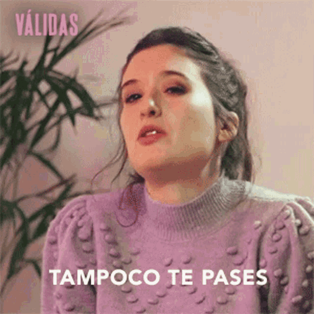 a woman wearing a purple sweater with tampoco te pases written on the bottom