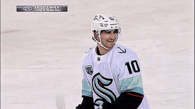 a hockey player in a white jersey with the number 11 on it