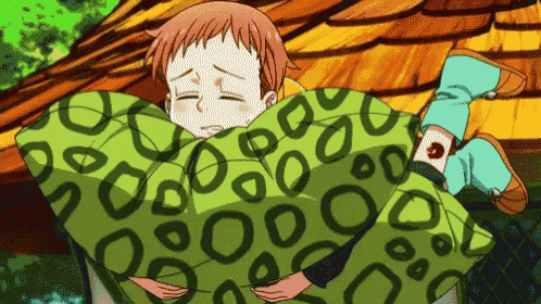 a cartoon character is wrapped in a blanket that has circles on it