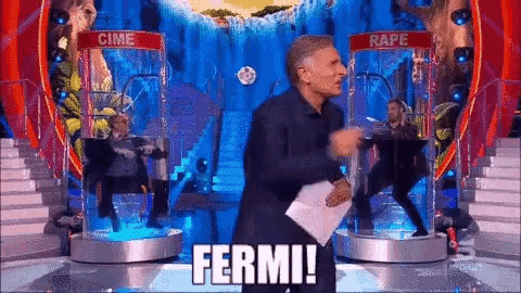 a man is holding a piece of paper in front of a sign that says ferme !