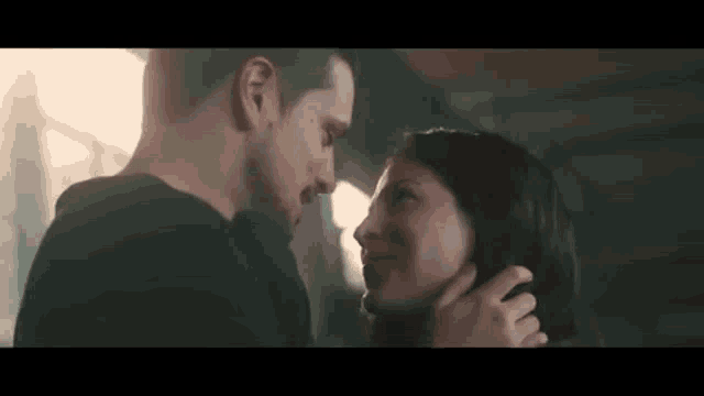a man and a woman are looking into each other 's eyes .