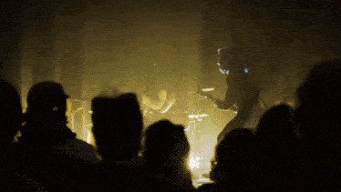 a group of people watching a band on stage