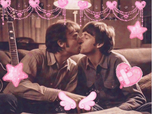 two men are kissing on a couch with pink hearts and stars around them