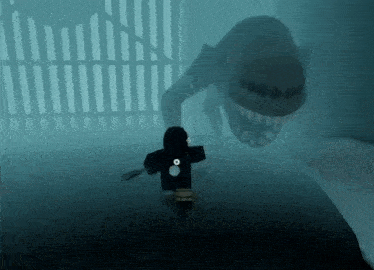 a person is holding a knife in front of a shark in a dark room .