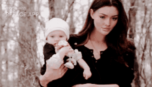 a woman is holding a baby in her arms and the image was made with the reface app