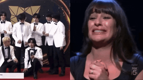 a woman is crying next to a group of men in suits