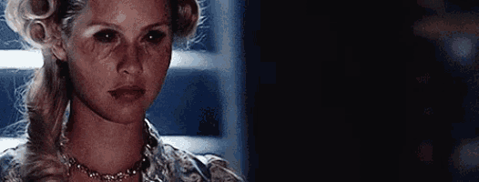 a close up of a woman with blood on her face .