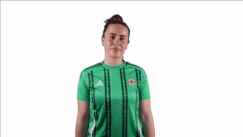 a woman wearing a green adidas shirt is giving two thumbs up