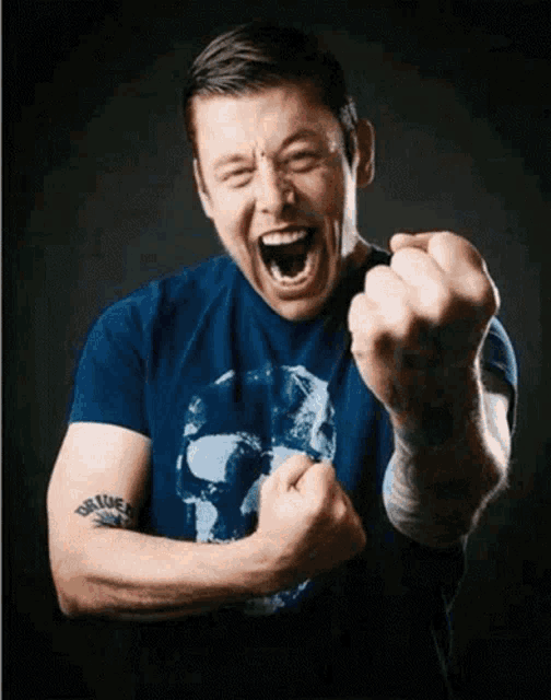a man in a blue shirt with a skull on it