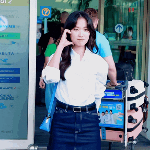 a woman standing in front of a sign that says china airlines on it