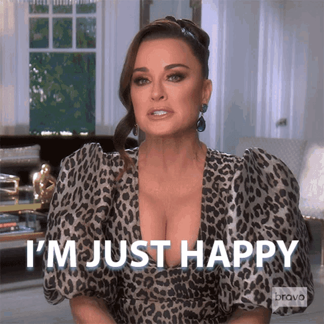 a woman wearing a leopard print dress says i 'm just happy